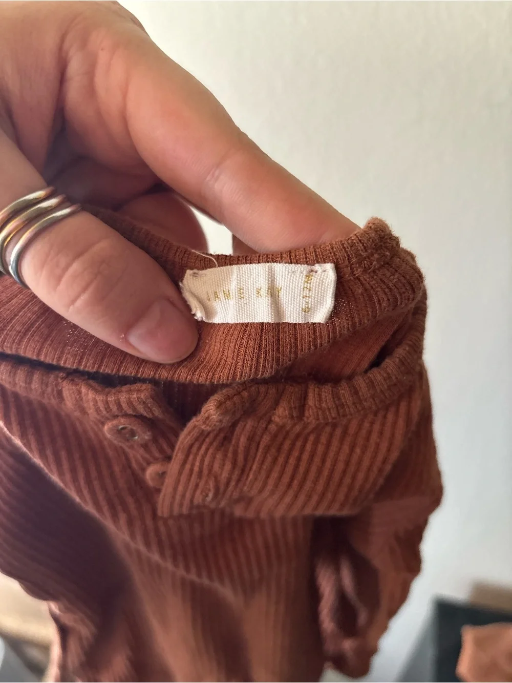 Jamie Kay Ribbed One-Piece Bodysuit in Rust Brown